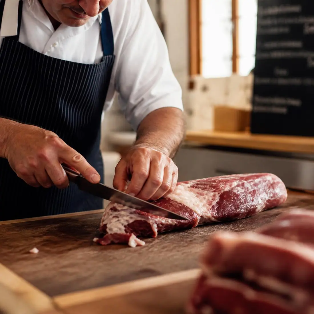 Butcher cutting meat